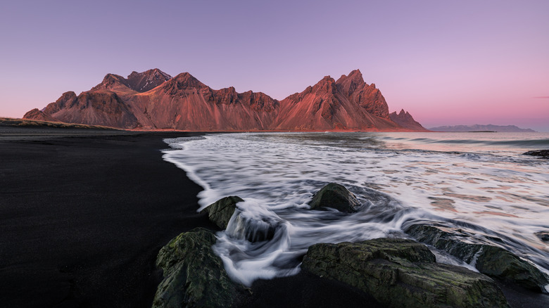 Sunset over black sand beach near Vestrahorn Mountain on the Stokksnes peninsula in Iceland