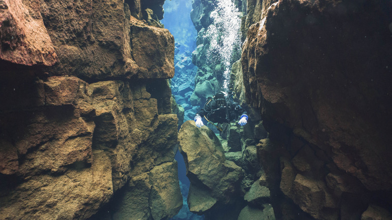 Someone diving in the Silfra Fissure, Iceland, with incredibly clear water