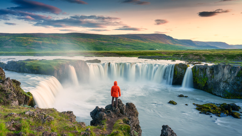 person looking at waterfall view