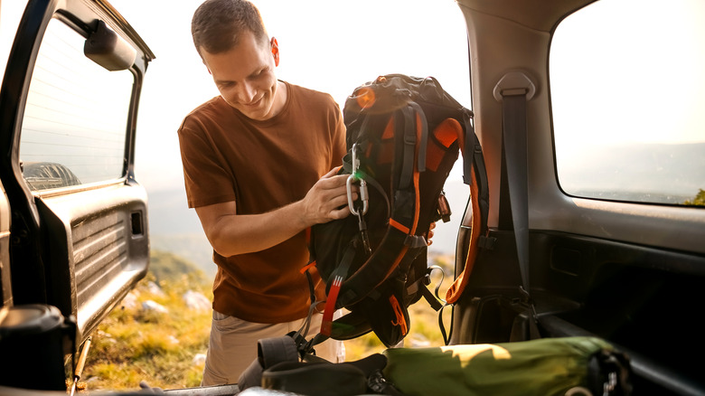 A man preparing for a hiking trip