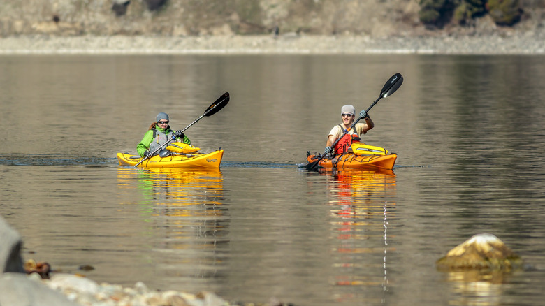 Two people kayaking on lake