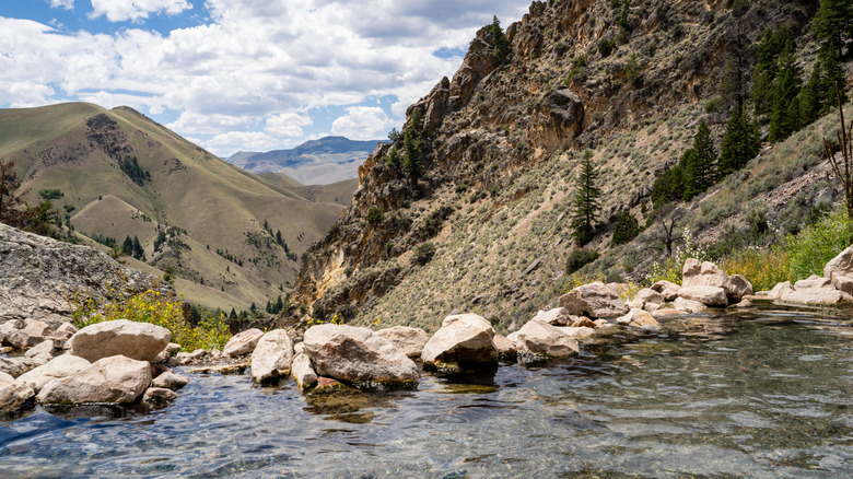 The surface of the Goldbug Hot Springs with rocks and mountains