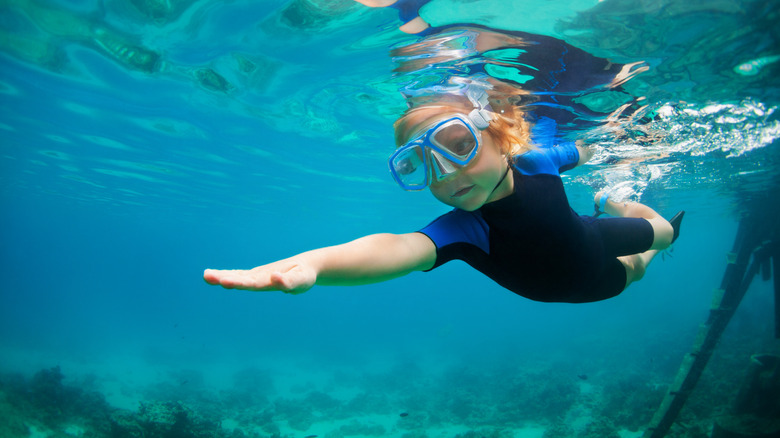 Snorkeling child swimming