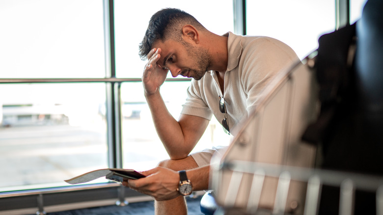 stressed man in airport