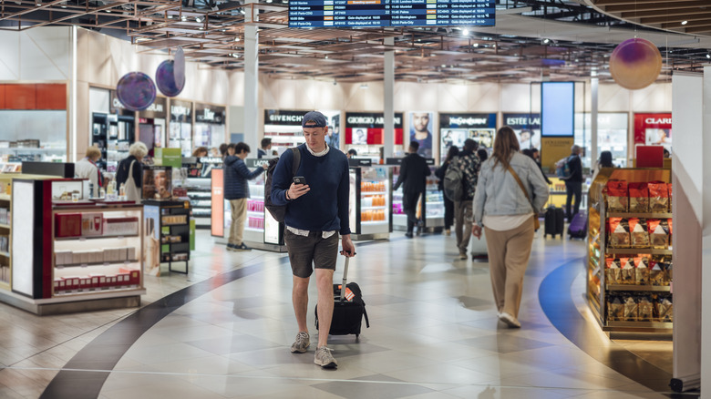 A traveler passing through duty free shops