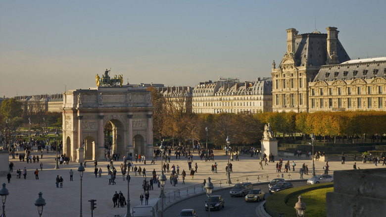 Paris street with arch and historical buildings