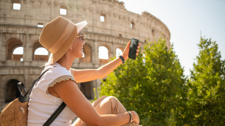 Person with phone at Rome's Colosseum