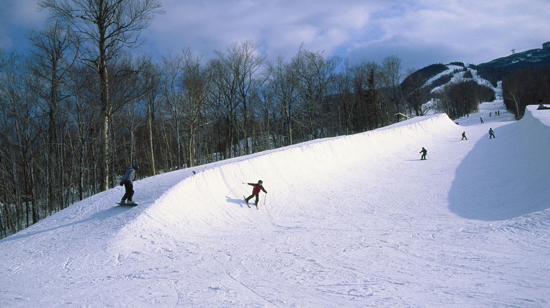 People skiing with view of mountain