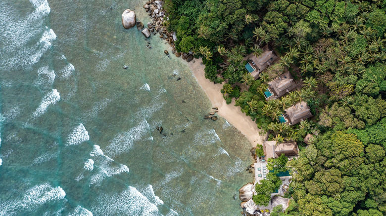 Aerial view of the forests, villas, and pools of Nikoi Island resort in Indonesia