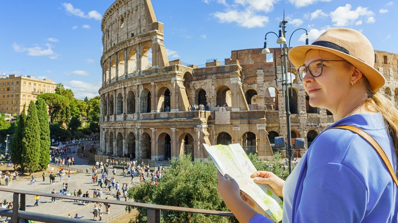 tourist holding map at colosseum