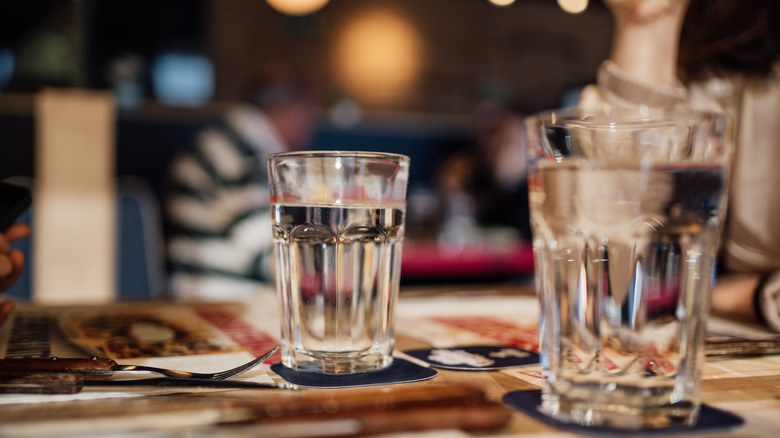 Two glasses of water on a restaurant table