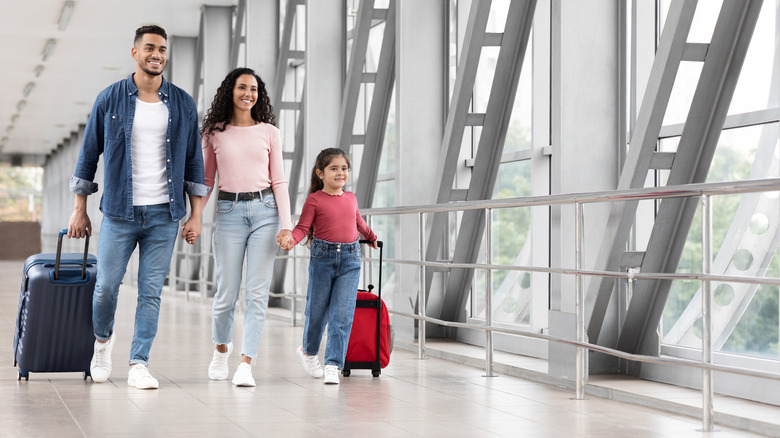 Family walking through an airport