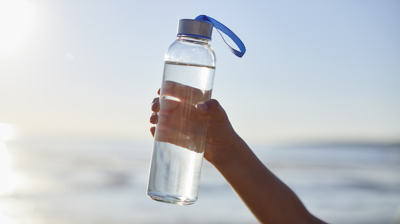 Person holding a reusable water bottle