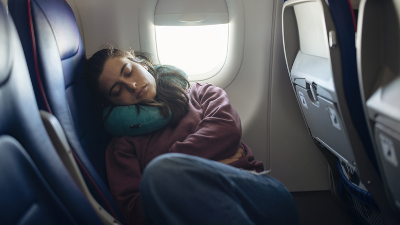 A woman sleeping in a plane