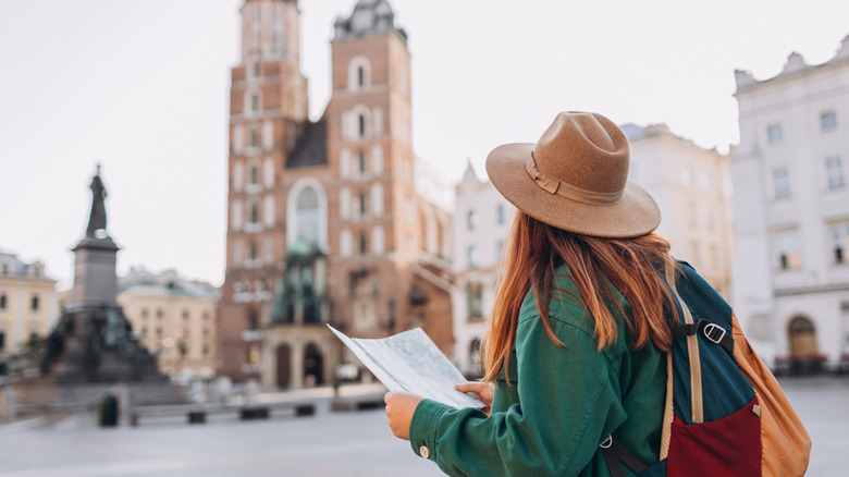 A woman exploring a market square in Krakow