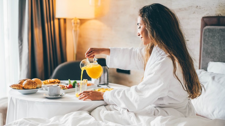 Woman with room service breakfast
