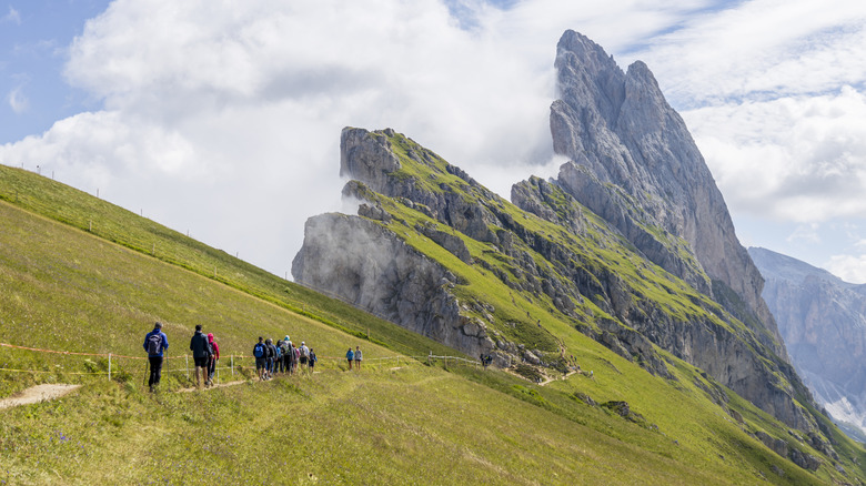 Hikers walking to the summit of Seceda in the Italian Dolomites