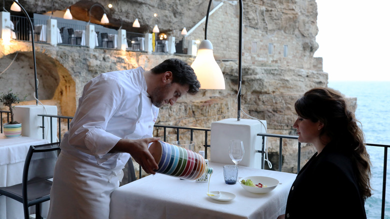 woman being served at Grotta Palazzese restaurant