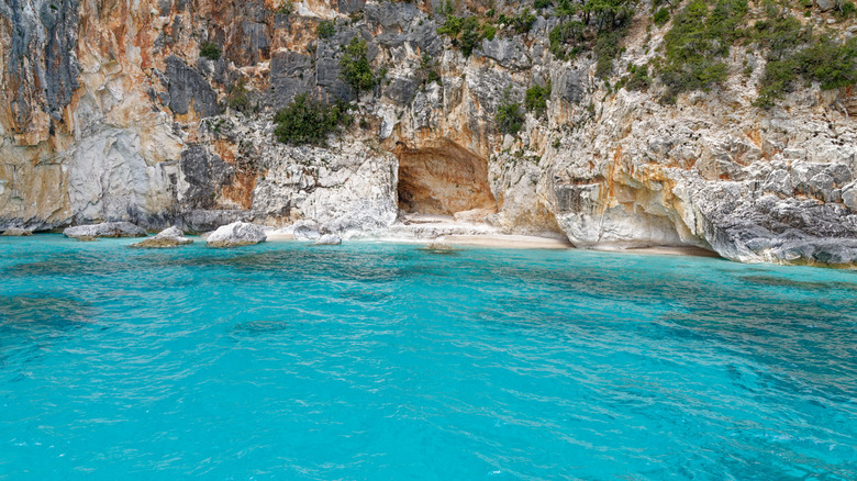 Limestone cliffs and turquoise water at the Pools of Venus in Sardinia