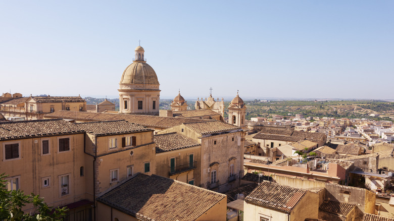 View over tiled rooftops of Noto, Sicily and dome of St. Nicholas cathedral