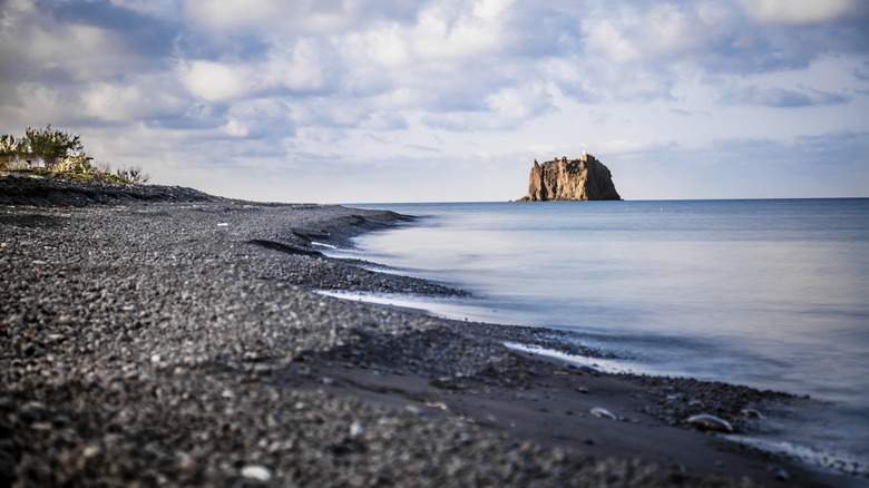 Black sand beach with view of Strombolicchio