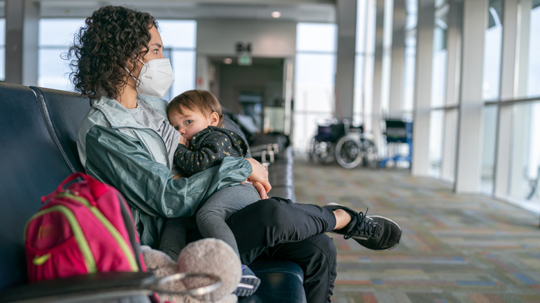 A mother nursing at an airport