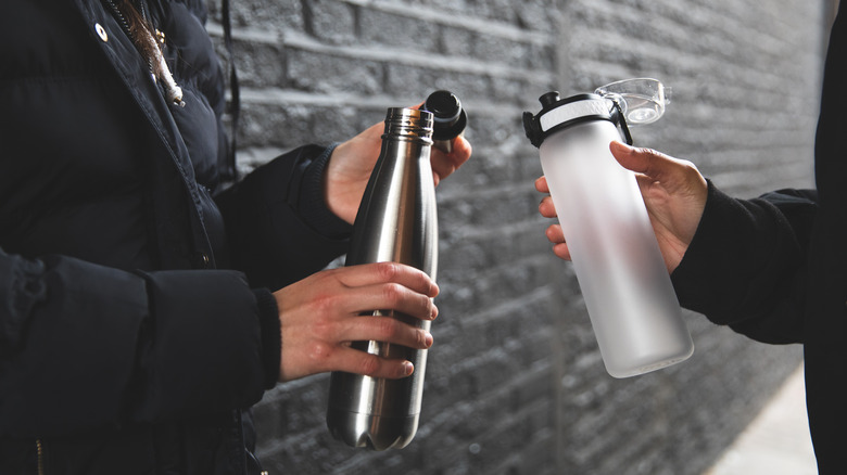 Couple with reusable water bottles