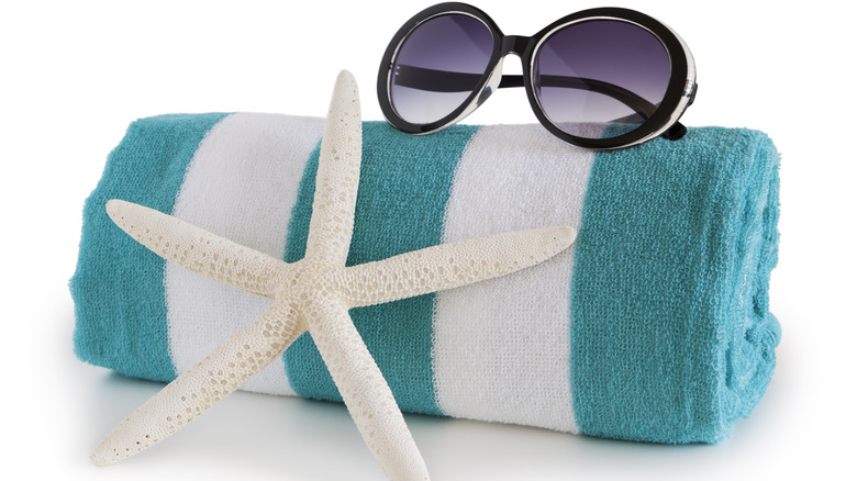A beach towel and sunglasses