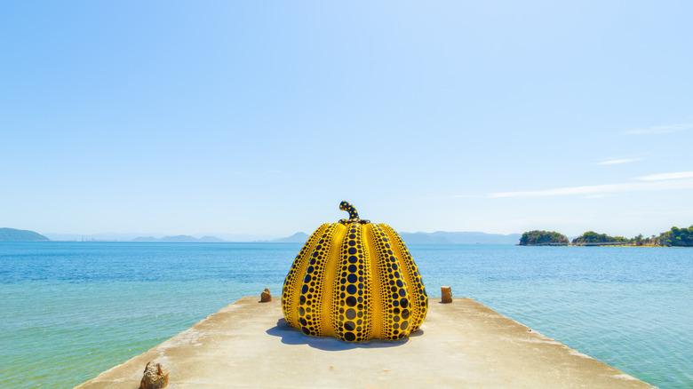 Yayoi Kusama's pumpkin sculpture on a pier jutting into the Seto Inland Sea