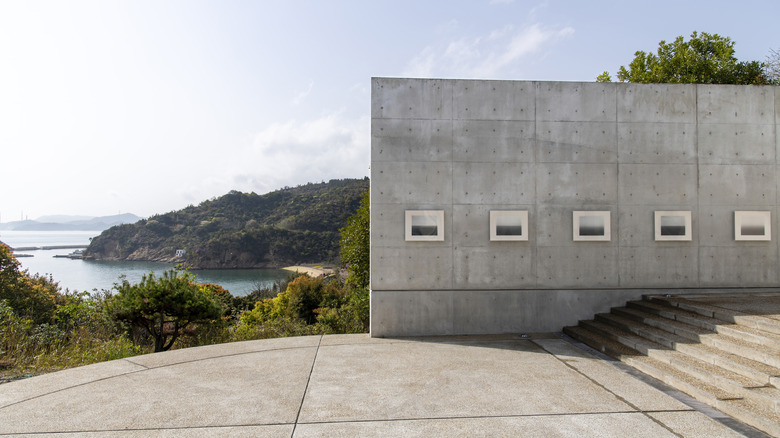 A concrete gallery wall of the Benesse House Museum with view of Seto Inland Sea in backdrop