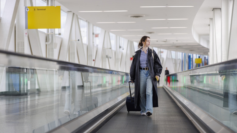 A woman walking through a New York airport