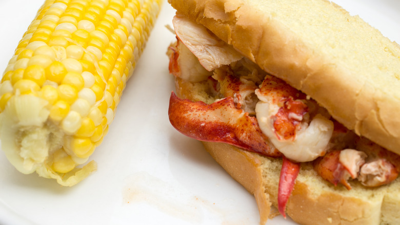 Connecticut-style hot buttered lobster roll with corn on the cob