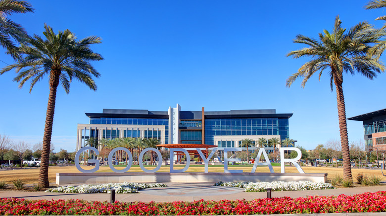 A municipal building with palm trees against a blue sky.