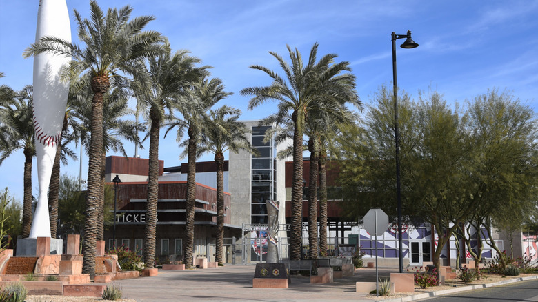 A municipal building with palm trees against a blue sky.