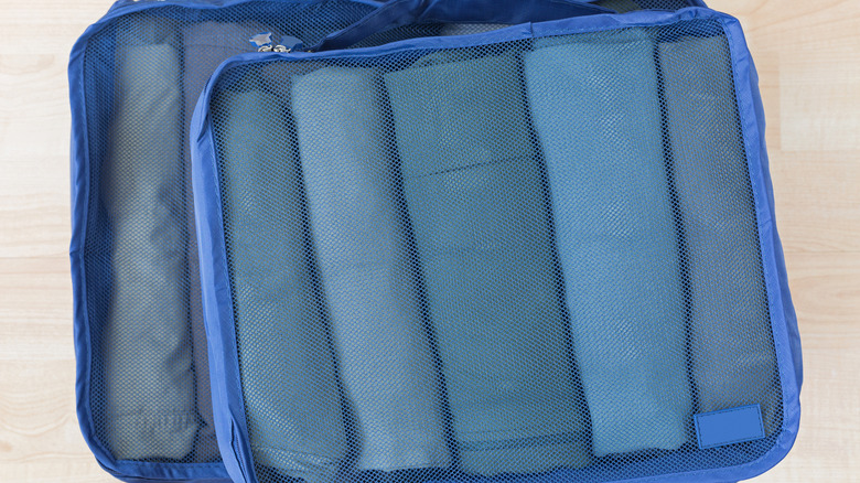 Blue packing cubes with clothes