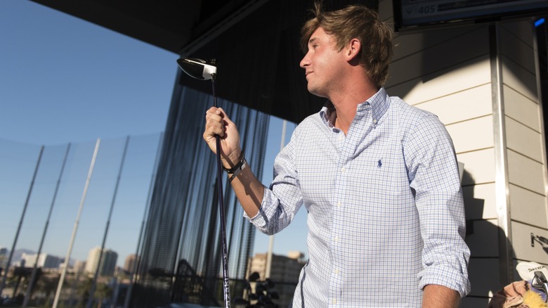 Man at Topgolf Las Vegas with the Strip in the background.