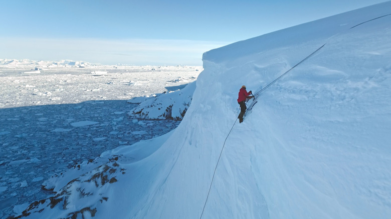 Person using ropes to ice climb in Antarctica