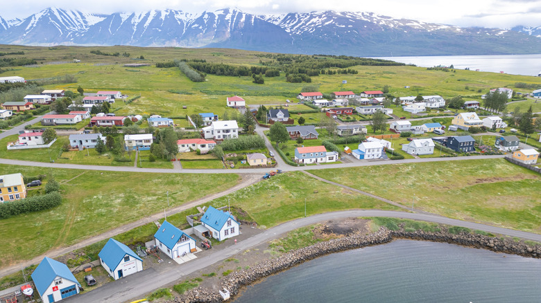 Aerial view of Hrísey with snowcapped mountains