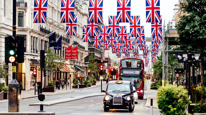 London road with english flags and cars