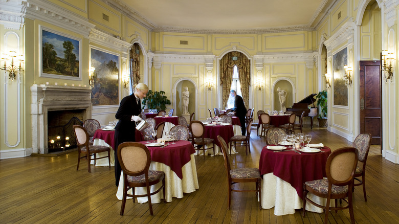 staff preparing tables in Oheka Castle's fine dining room