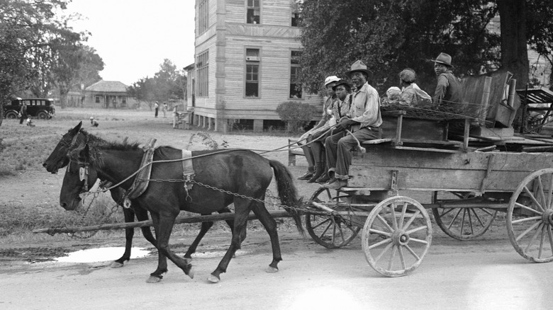 People on a horse-drawn wagon in the 1930s in Opelousas