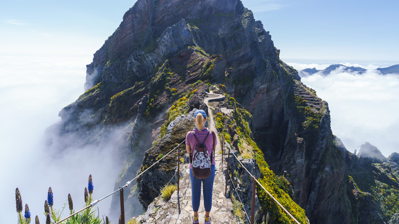 A person hiking the iconic trail from Pico Ruivo to Pico do Areeiro in Madeira, Portugal