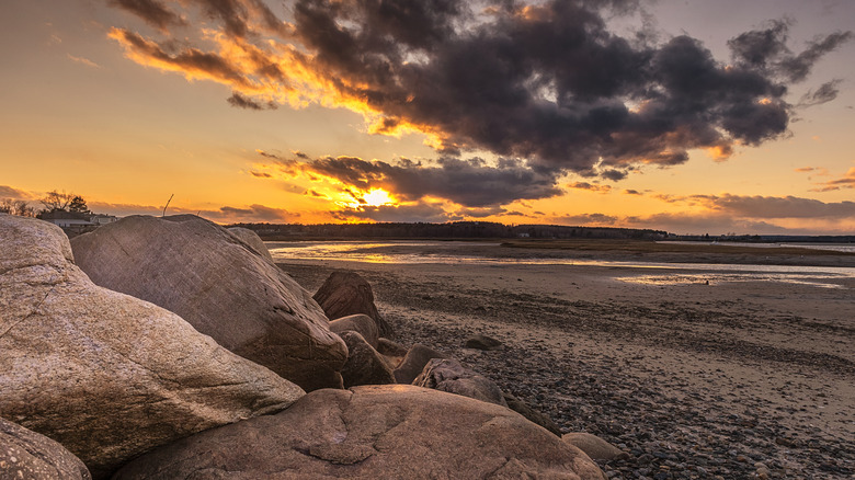 Sunset by the beach with boulders in Scarborough, Maine