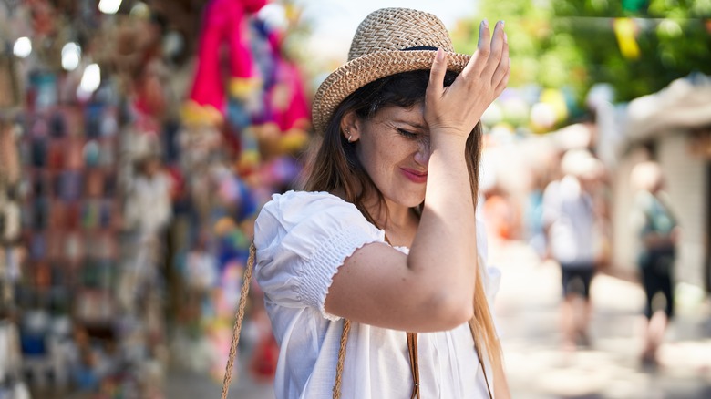 Stressed woman face palms while on vacation