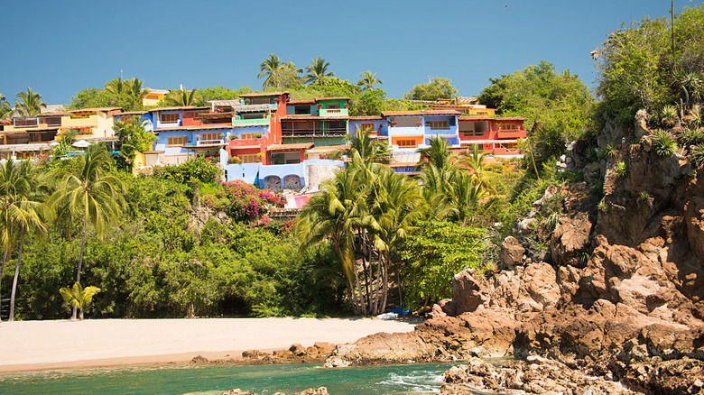 Colorful casitas above a beach