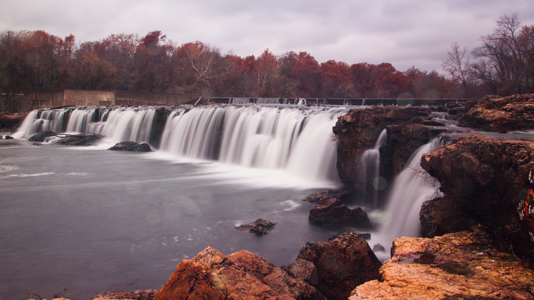 Grand Falls in Joplin, Missouri, surrounded by fall foliage