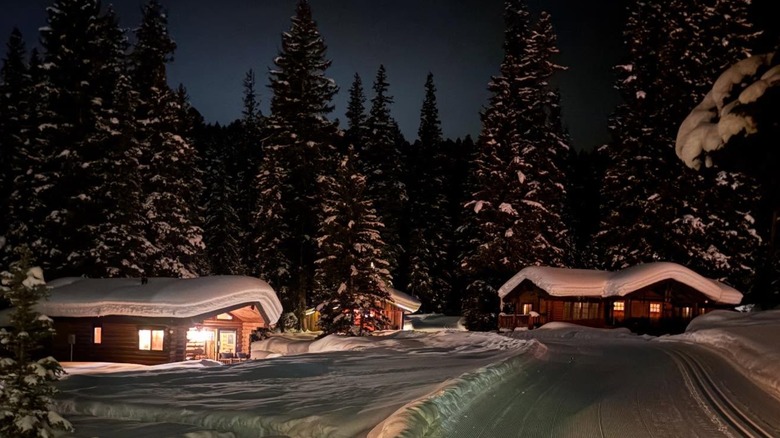 Lone Mountain Ranch cabins at night covered in snow