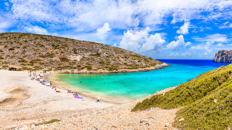 People relaxing on a beach on the Greek island of Astypalaia