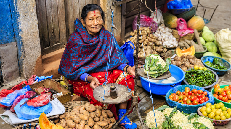 Nepali woman offering food