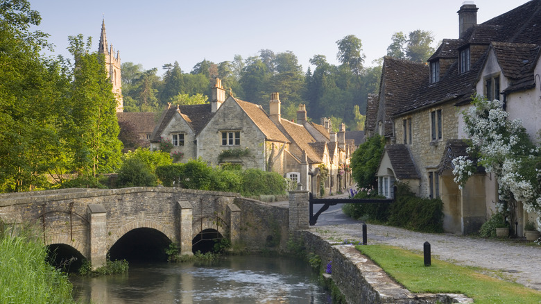 River running through the pretty village of Castle Combe with historic houses & church